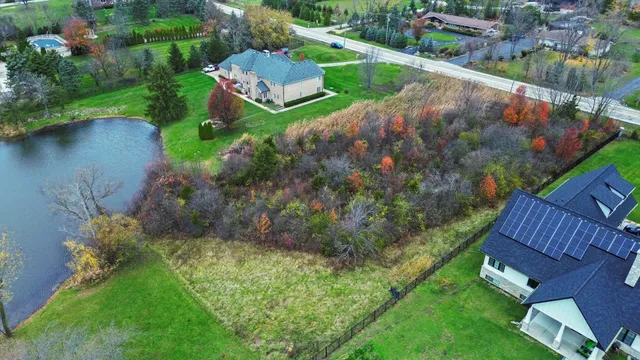 an aerial view of a house with outdoor space and street view