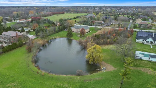 an aerial view of a house with a yard