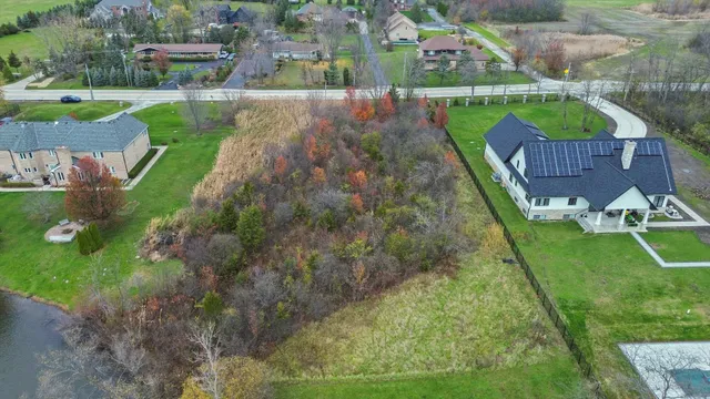 an aerial view of a house with a garden and yard
