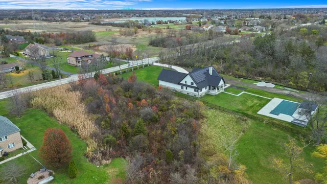 an aerial view of a house with a lake view