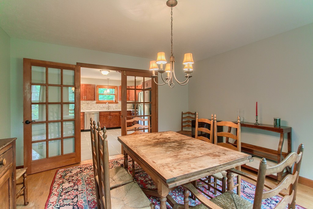 207 Beaman Road Princeton, MA 01541 - Photo 13 of 30 a dining room with a table chairs and a wooden floor