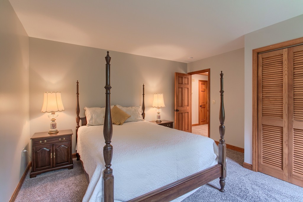 207 Beaman Road Princeton, MA 01541 - Photo 19 of 30 a bed room with a bed window and a mirror