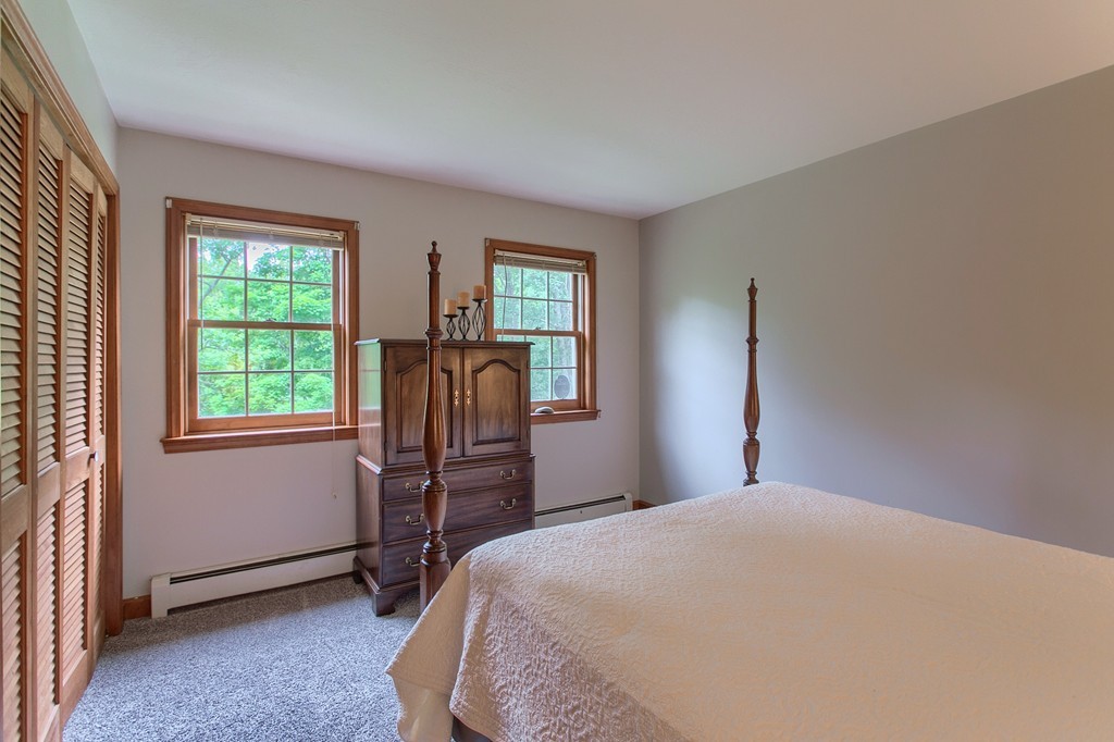 207 Beaman Road Princeton, MA 01541 - Photo 20 of 30 a bedroom with a bed and windows