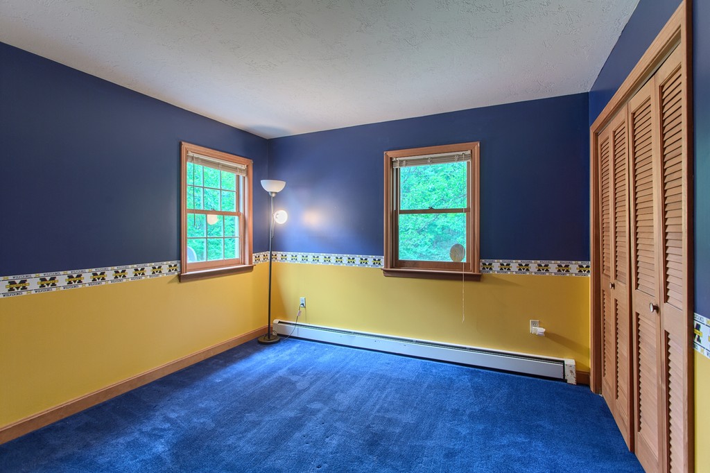 207 Beaman Road Princeton, MA 01541 - Photo 21 of 30 an empty room with wooden floor and windows