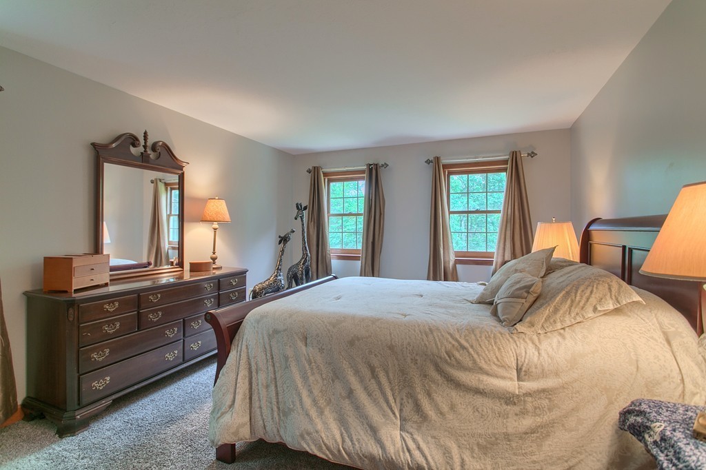 207 Beaman Road Princeton, MA 01541 - Photo 24 of 30 a bedroom with a bed and dresser with mirror