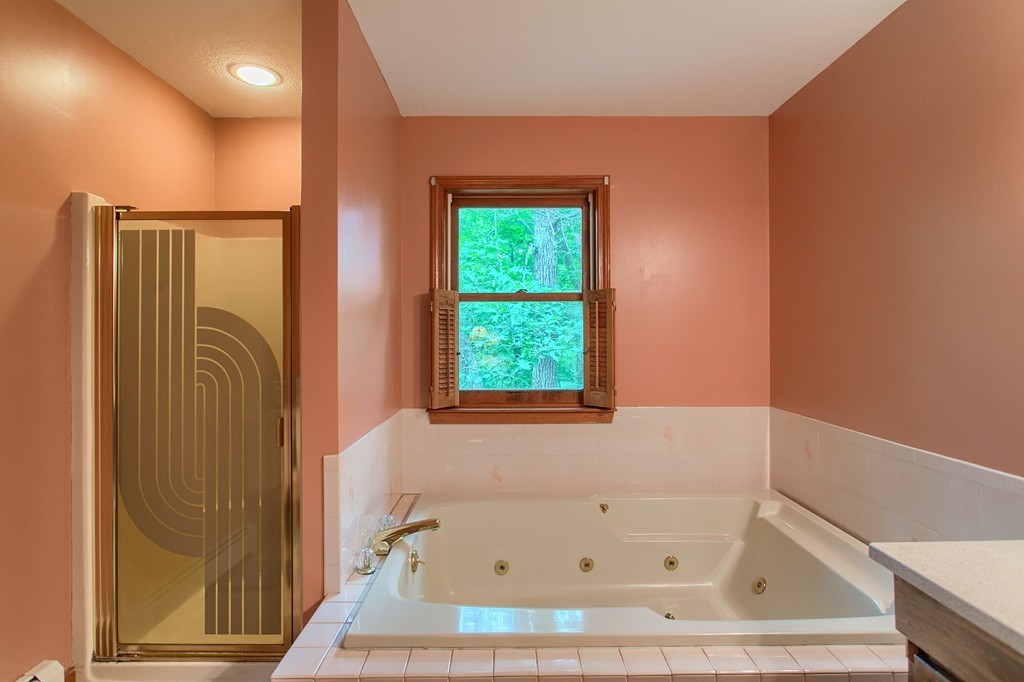 207 Beaman Road Princeton, MA 01541 - Photo 25 of 30 a bathroom with a bathtub and a window