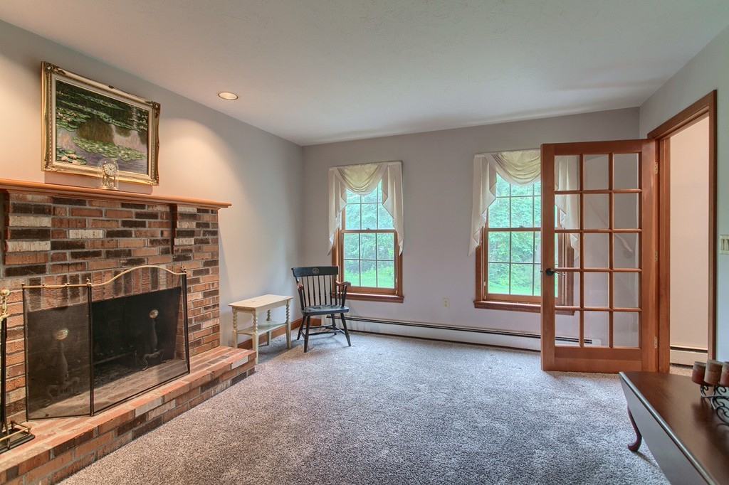 207 Beaman Road Princeton, MA 01541 - Photo 4 of 30 an empty room with furniture and a fireplace