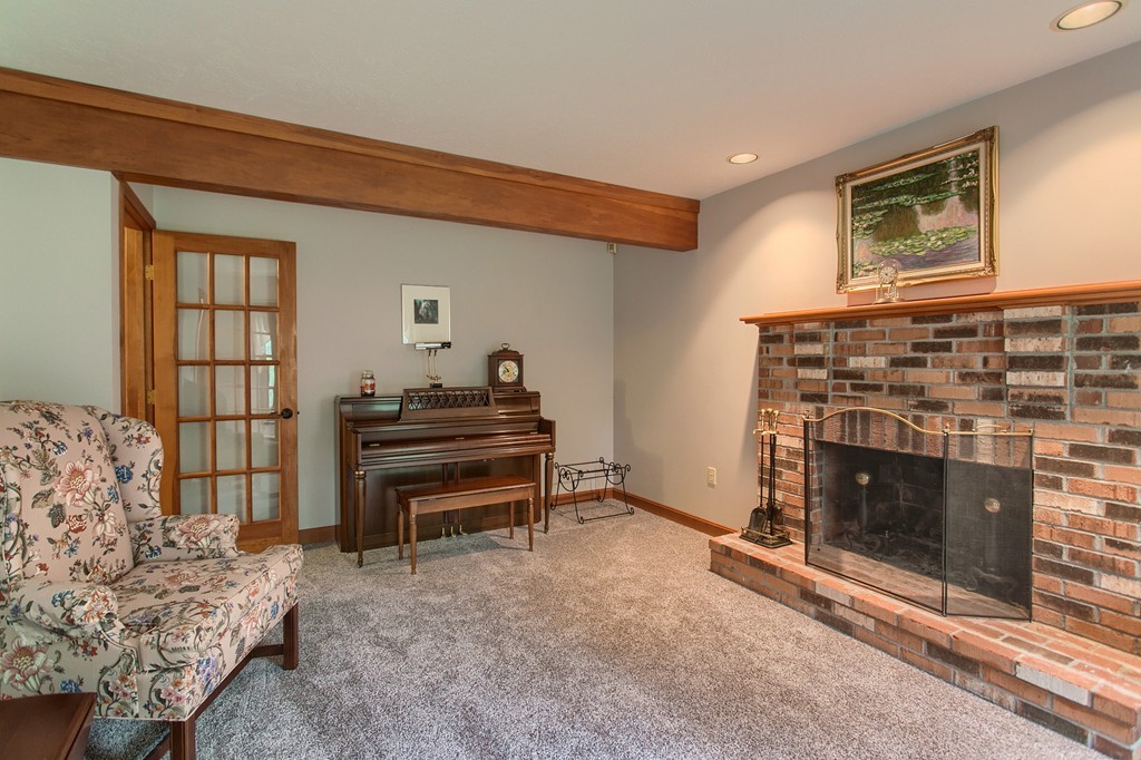 207 Beaman Road Princeton, MA 01541 - Photo 5 of 30 a living room with furniture a piano and a fireplace