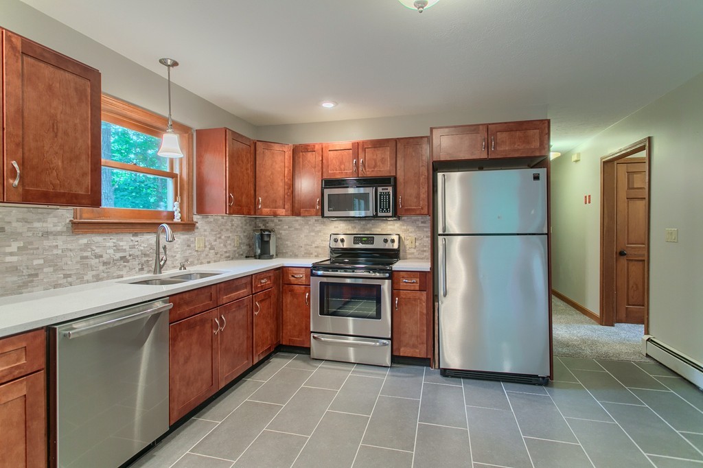 207 Beaman Road Princeton, MA 01541 - Photo 7 of 30 a kitchen with stainless steel appliances granite countertop a refrigerator a sink a stove a microwave and cabinets