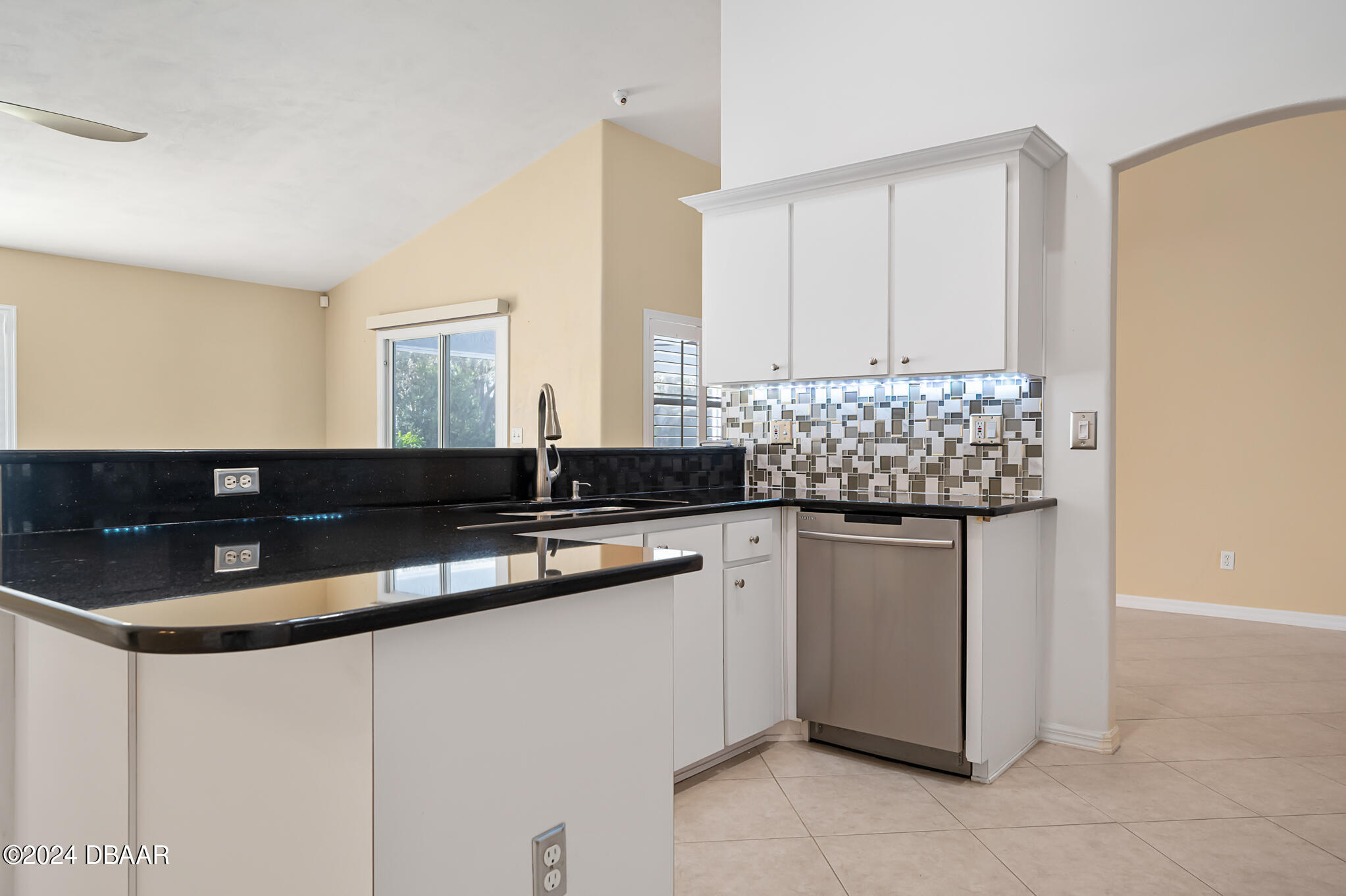 63 Spring Meadows Drive Ormond Beach, FL 32174 - Photo 11 of 49 a kitchen with stainless steel appliances granite countertop a sink and a white cabinets