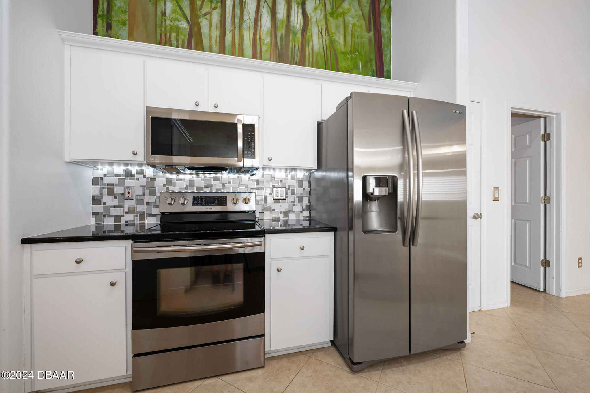 63 Spring Meadows Drive Ormond Beach, FL 32174 - Photo 12 of 49 a kitchen with stainless steel appliances granite countertop a refrigerator stove and microwave