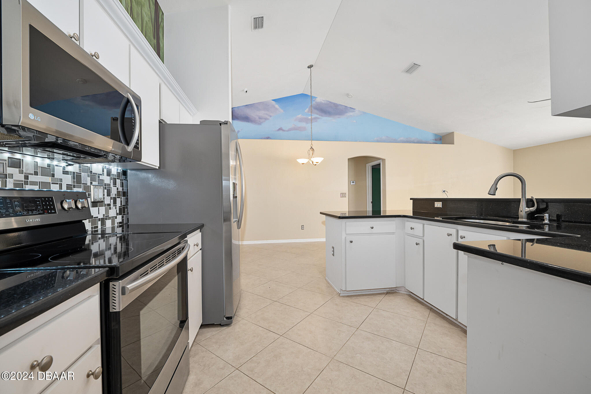 63 Spring Meadows Drive Ormond Beach, FL 32174 - Photo 13 of 49 a kitchen with stainless steel appliances a stove microwave and refrigerator