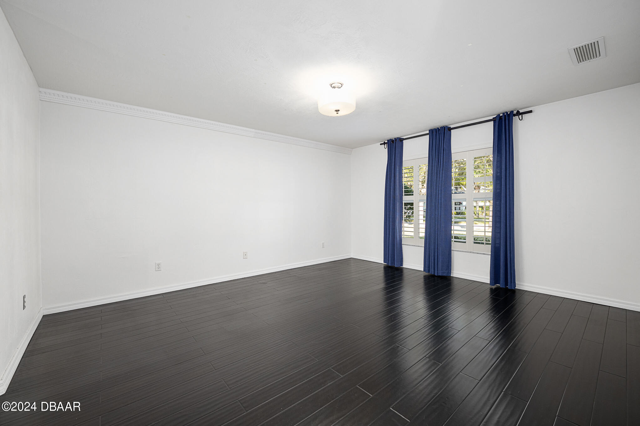 63 Spring Meadows Drive Ormond Beach, FL 32174 - Photo 18 of 49 a view of an empty room with wooden floor and a window