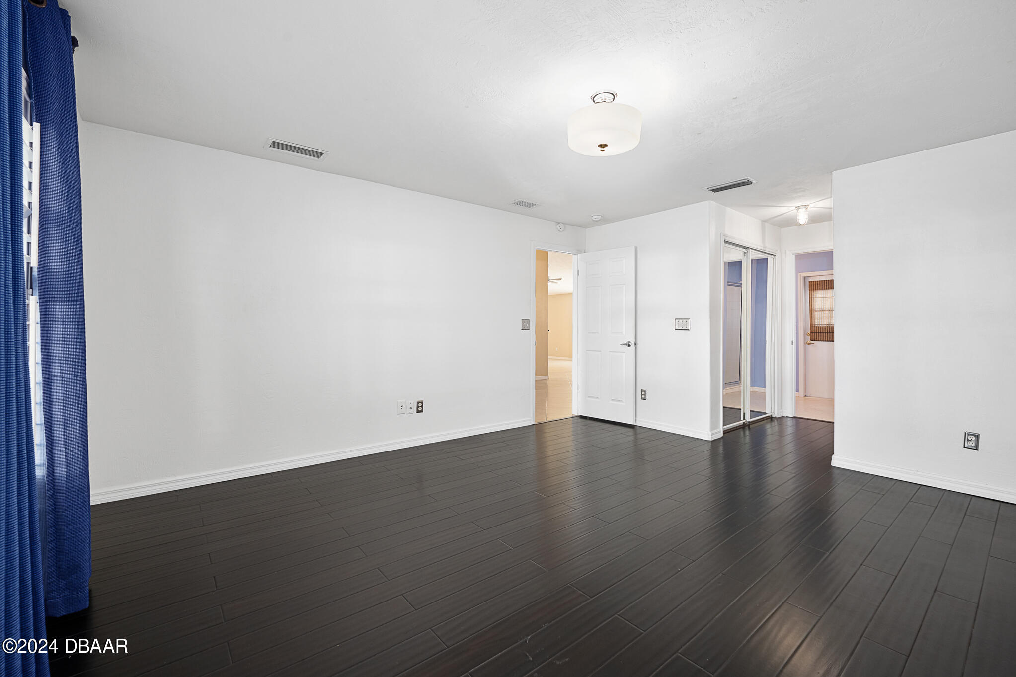 63 Spring Meadows Drive Ormond Beach, FL 32174 - Photo 19 of 49 a view of an empty room with wooden floor