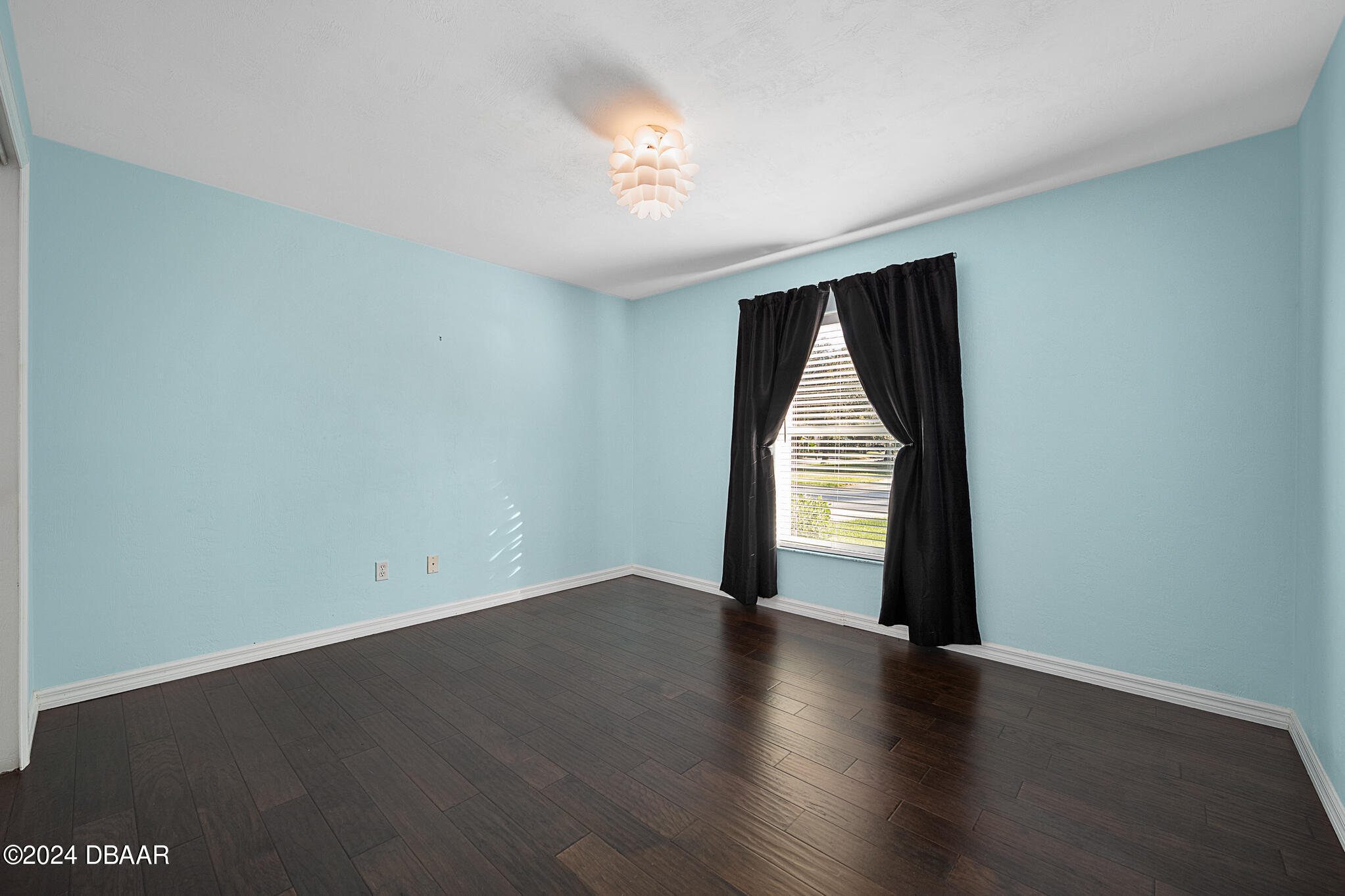 63 Spring Meadows Drive Ormond Beach, FL 32174 - Photo 28 of 49 an empty room with wooden floor and windows