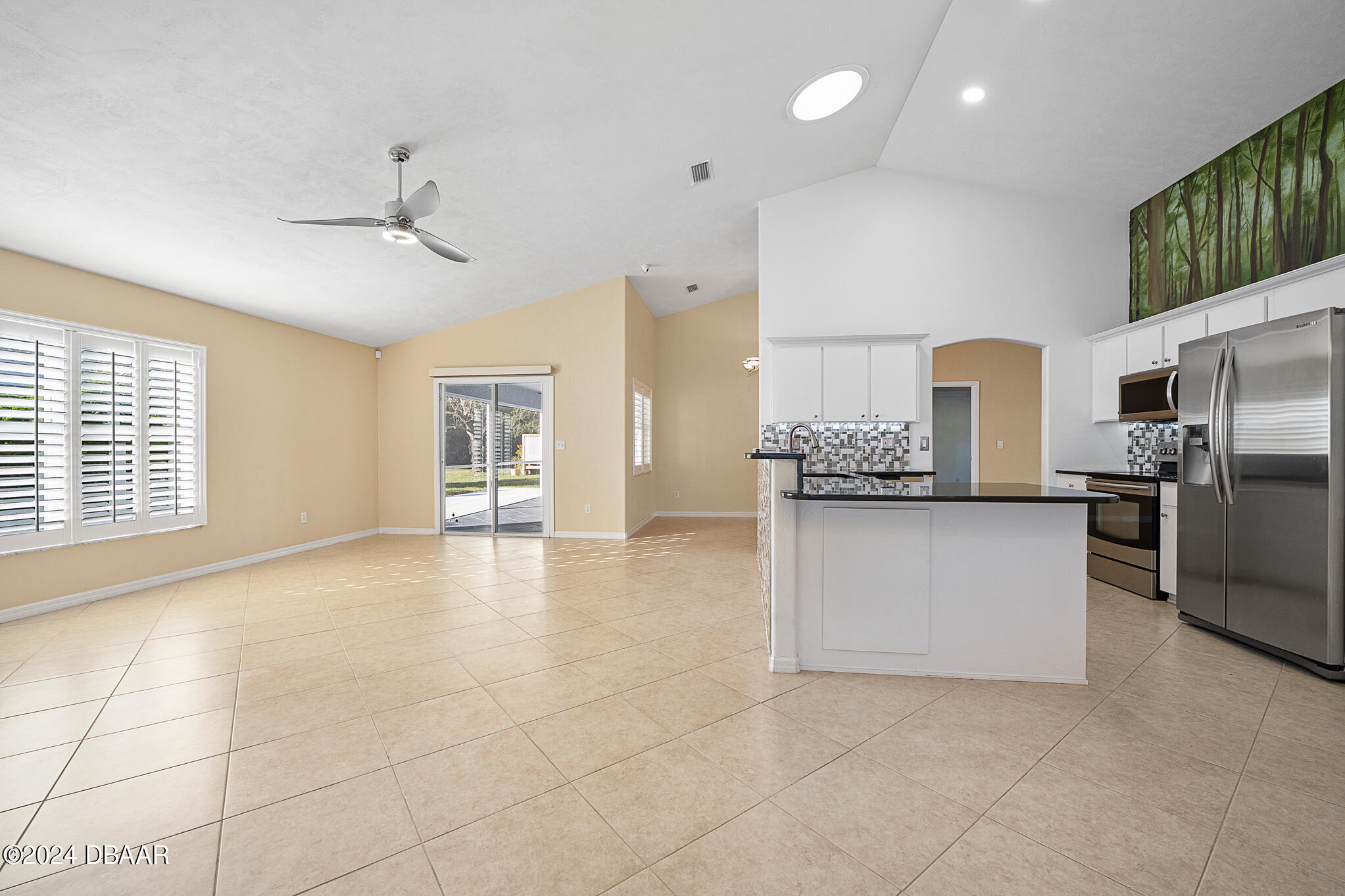 63 Spring Meadows Drive Ormond Beach, FL 32174 - Photo 10 of 49 a large white kitchen with a refrigerator a stove a sink and a cabinets