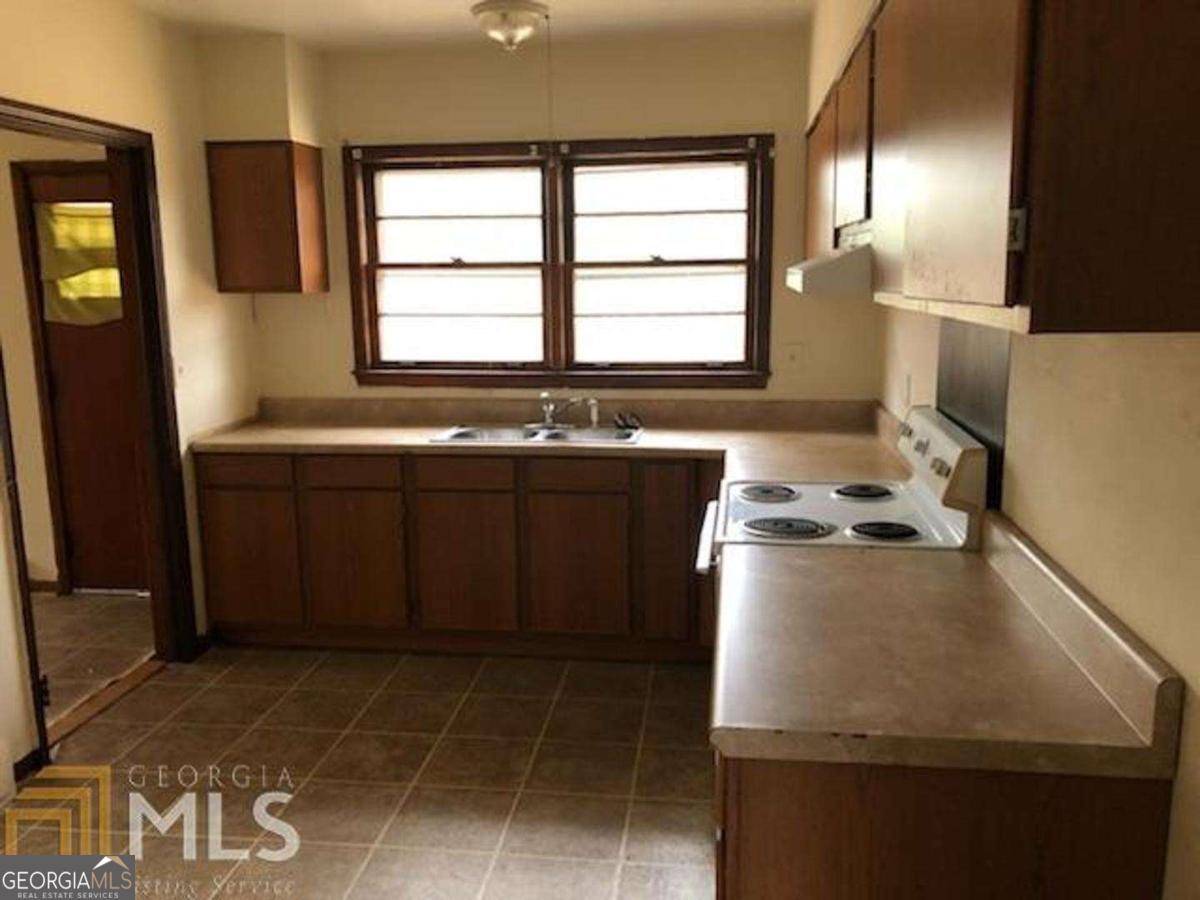 329 McDonough Road Jackson, GA 30233 - Photo 5 of 11 a kitchen with a sink appliances and cabinets