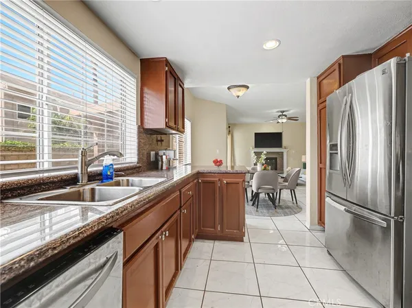 a kitchen with stainless steel appliances granite countertop a sink refrigerator and cabinets