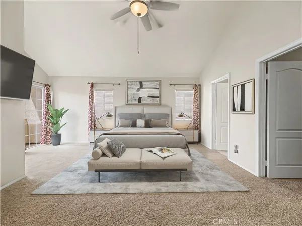 a bedroom with a large bed and a couch