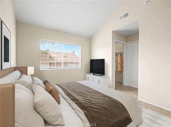 a bedroom with a bed and a television