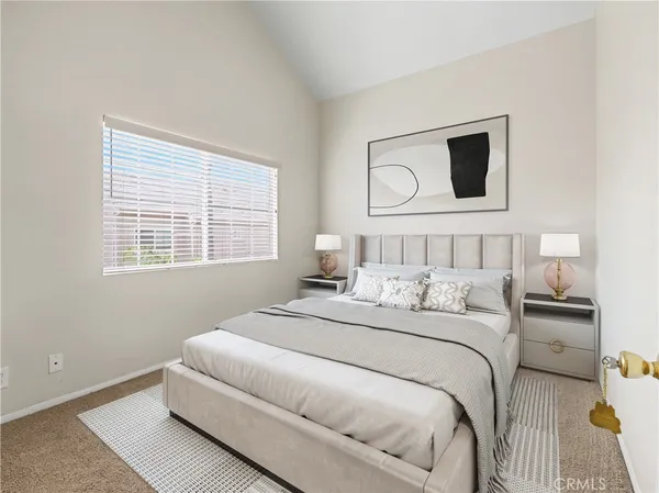 a bedroom with a large bed and a window