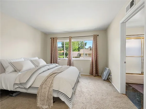 a bedroom with a bed and a window