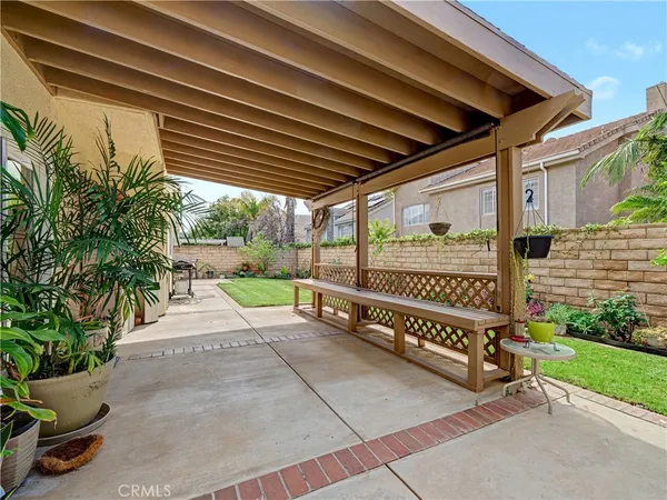 a view of a porch with furniture and garden
