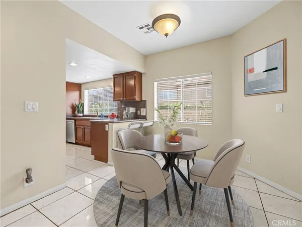 a view of a dining room with furniture and a window