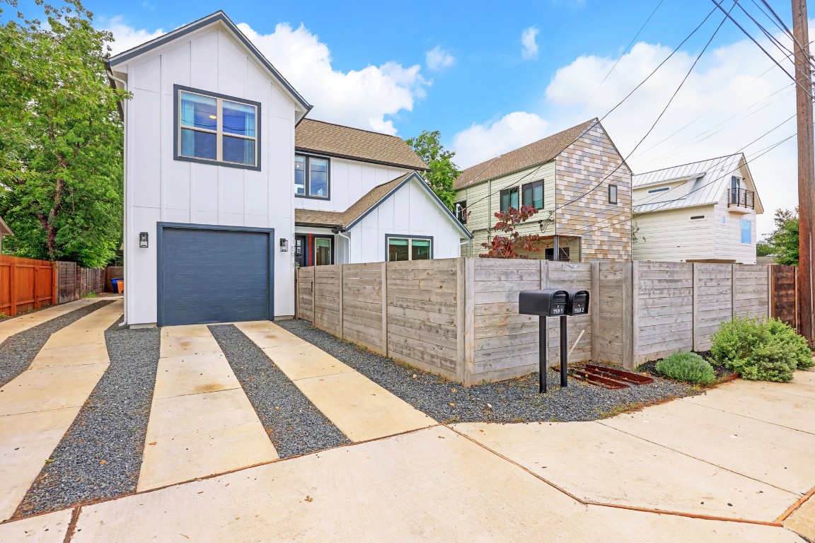 1159 Webberville Road, Unit A Austin, TX 78721 - Photo 1 of 1 a front view of a house with a yard and garage