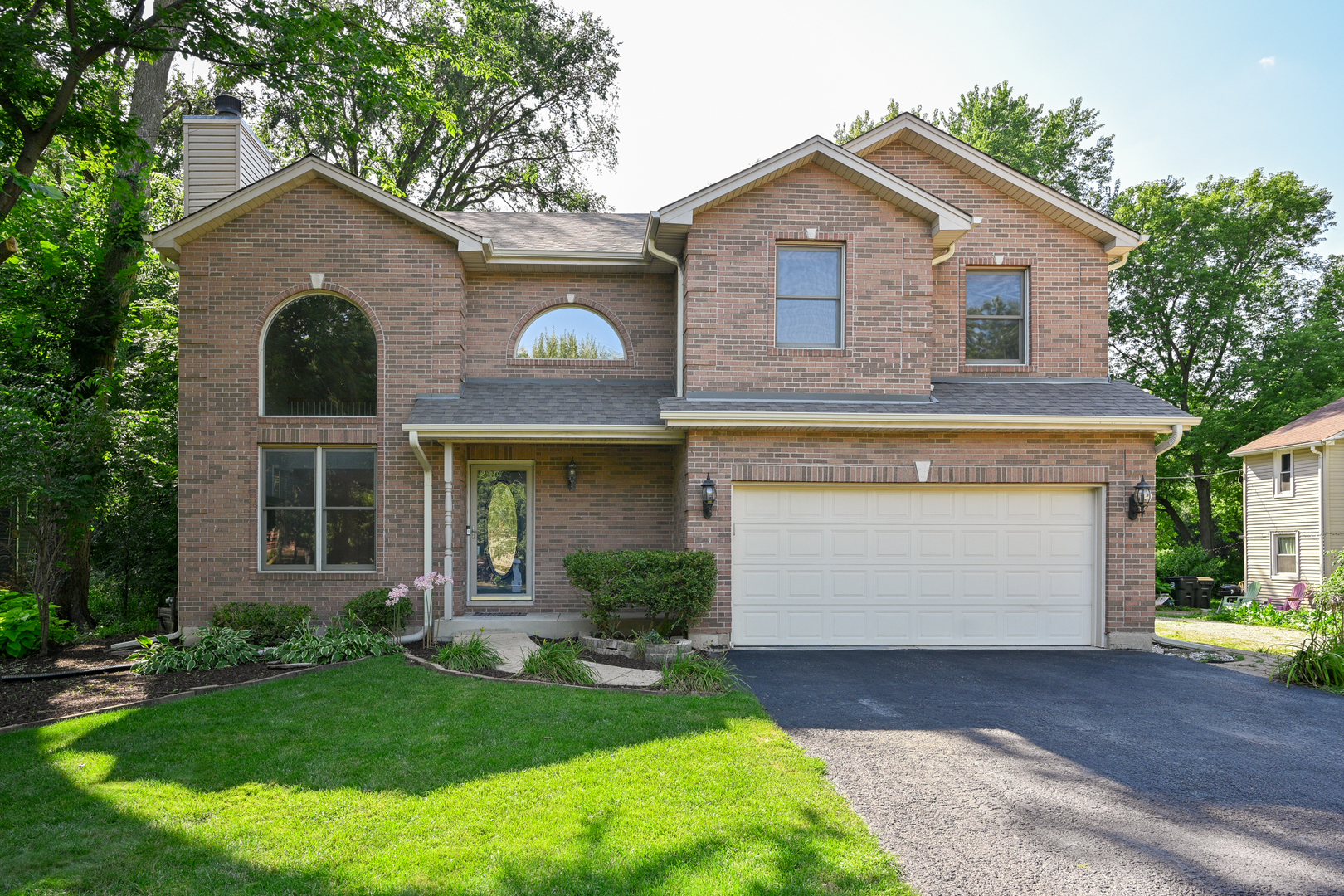 3S178 Pattermann Road Warrenville, IL 60555 - Photo 1 of 33 a front view of a house with garden
