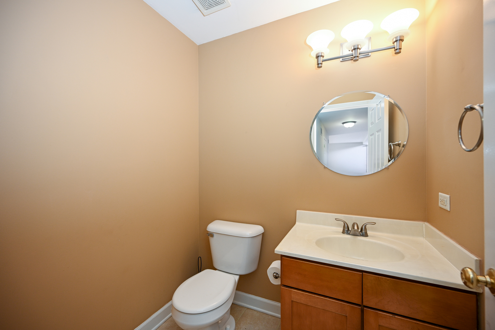 3S178 Pattermann Road Warrenville, IL 60555 - Photo 12 of 33 a bathroom with a toilet a sink and mirror