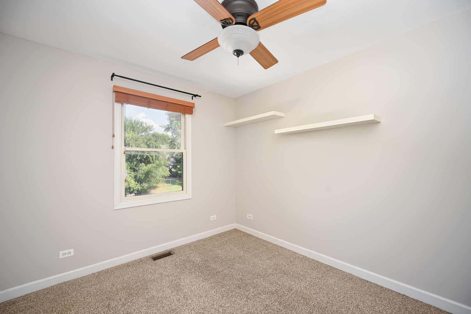 3S178 Pattermann Road Warrenville, IL 60555 - Photo 24 of 33 an empty room with a window and a ceiling fan