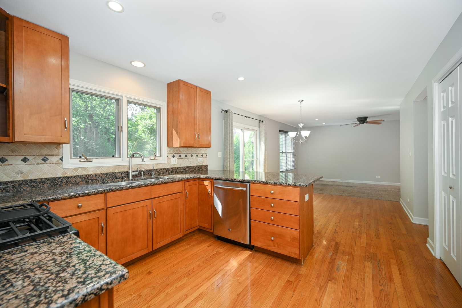 3S178 Pattermann Road Warrenville, IL 60555 - Photo 7 of 33 a large kitchen with wooden floors and a sink