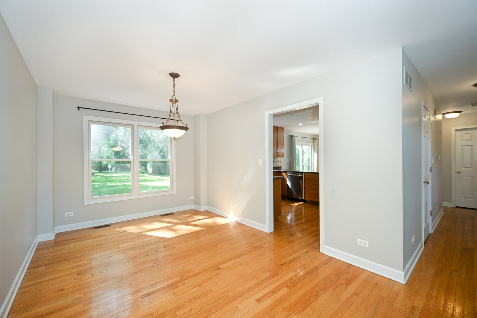 3S178 Pattermann Road Warrenville, IL 60555 - Photo 8 of 33 a view of an empty room with wooden floor and a window