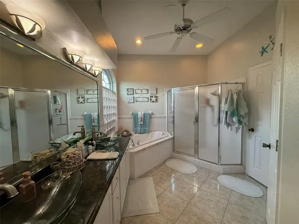 a bathroom with a double vanity sink a large mirror and shower