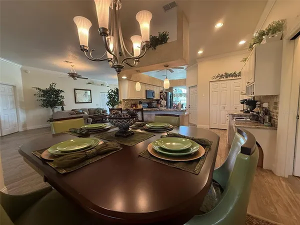 a view of a dining room with furniture and a chandelier