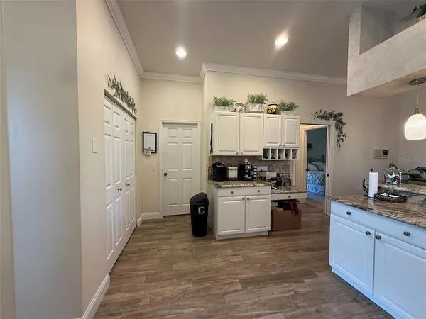 a kitchen with kitchen island granite countertop a refrigerator stove top oven and sink