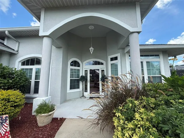 a front view of a house with potted plants