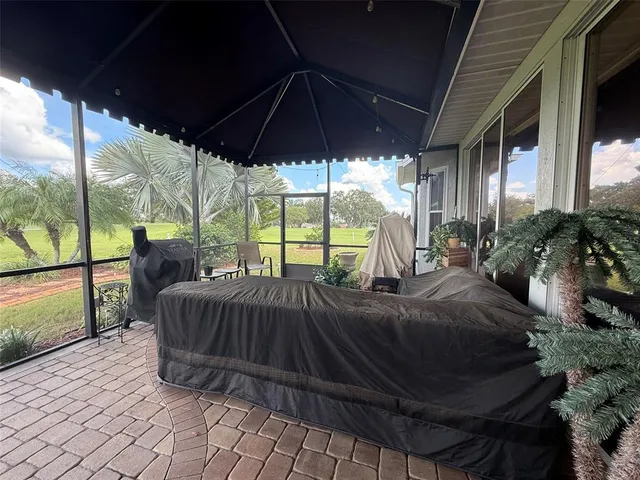 a view of backyard with roof and outdoor seating