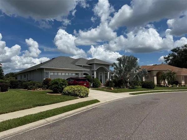 a front view of a house with a yard and outdoor seating
