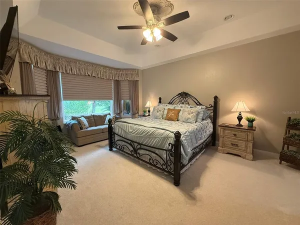 a bedroom with furniture and a large window