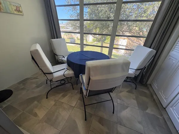 a view of a livingroom with furniture and a window
