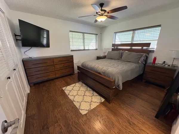 a bedroom with a bed and a flat screen tv