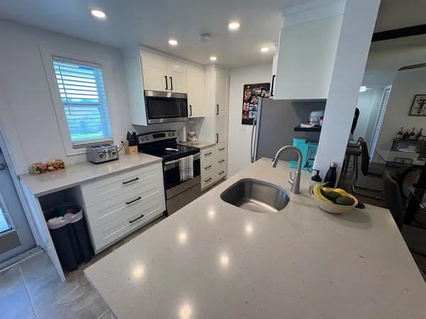 a kitchen with refrigerator and window