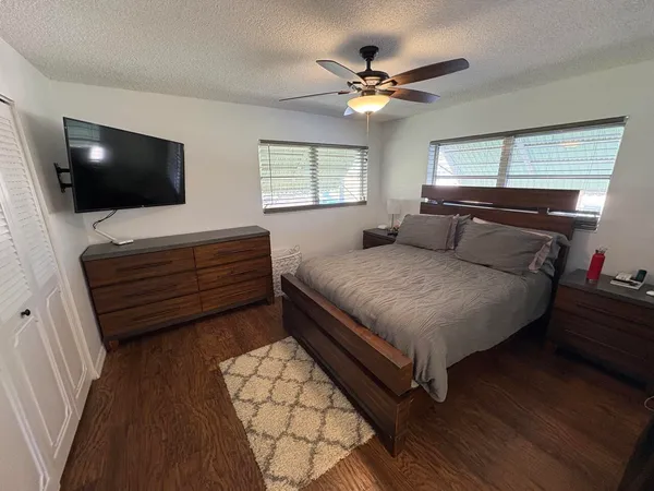 a bedroom with a bed and a flat screen tv