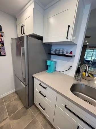 a kitchen with stainless steel appliances a refrigerator and a sink