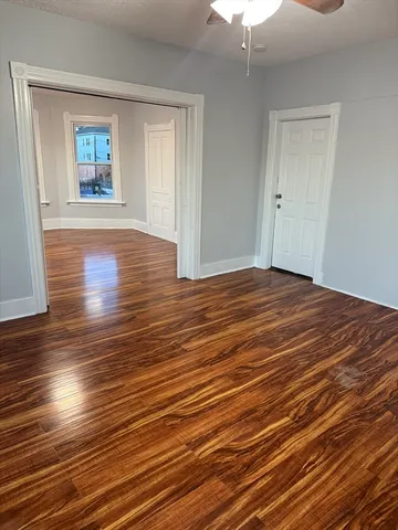 a view of a room with wooden floor window and a kitchen