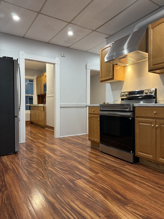 2 Orne Street, Unit 2 Worcester, MA 01605 - Photo 3 of 10 a kitchen with stainless steel appliances wooden floor and a refrigerator