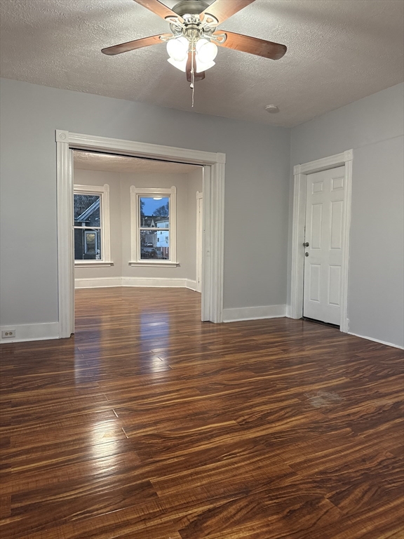 2 Orne Street, Unit 2 Worcester, MA 01605 - Photo 4 of 10 an empty room with wooden floor chandelier and windows