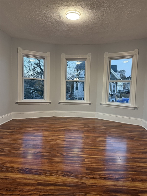 2 Orne Street, Unit 2 Worcester, MA 01605 - Photo 6 of 10 a view of an empty room with wooden floor and windows